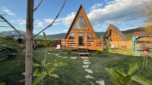 a group of small houses in a yard at Oda Riverside Cottages in Aragvispiri