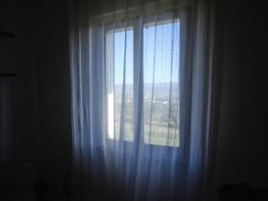 a window with white curtains in a room at Il Giardino Sopra le Nuvole in Città di Castello +37 photos