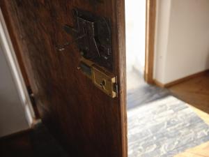 a wooden door with a latch on a room at Il Giardino Sopra le Nuvole in Città di Castello