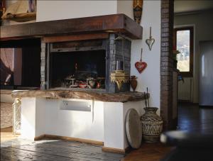 a stone fireplace in a living room with a fire place at Il Giardino Sopra le Nuvole in Città di Castello