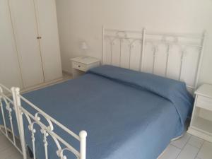 a bedroom with a white bed with a blue blanket at Casa Regina Elena II in Termoli +5 photos