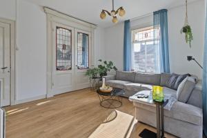 a living room with a couch and a table at Authentic stay in Alkmaar in Alkmaar