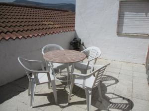 a table and four chairs on a patio at VUT El Risco in Amavida