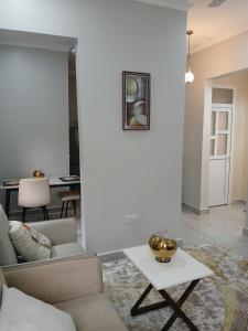 a living room with a couch and a table at Blesauz Apartments in Dar es Salaam
