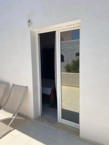a sliding glass door to a balcony with a bedroom at Cocon au bord de l eau in Zarzis