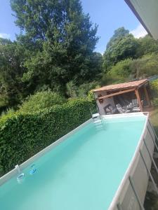 a view of a swimming pool with a hedge at Casa Allariz in Allariz