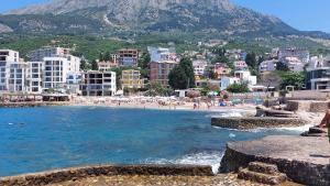 a view of a beach with buildings and people at Apartments Diva in Dobra Voda