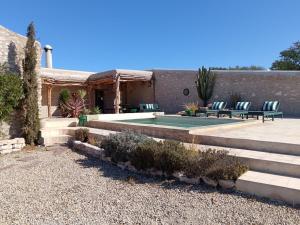 a house with a swimming pool in a yard at Dar Tikida - Luxury Beach Villa - 8 people in Sidi Kaouki