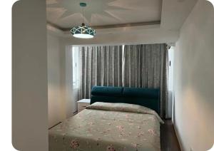 a small bedroom with a bed and a window at Brecani Apartment in Shëngjin