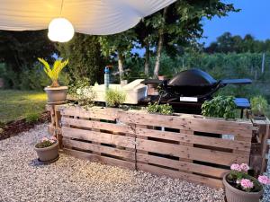 a grill with a bunch of plants in a garden at Pineta Apartment with Exclusive Pool in Campo di Pietra