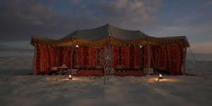 a large tent on the beach in the sand at ama in Ismant