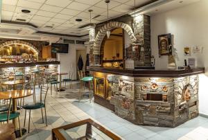 a bar in a restaurant with a stone wall at Hotel Diana - in the heart of Koroni in Koroni