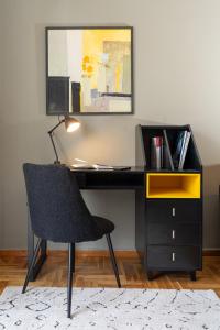 a black desk with a chair and a yellow drawer at Prime location - 2 bd Boutique apartment in Thessaloniki +47 photos