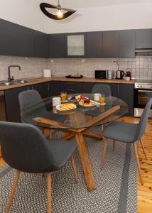 a kitchen with a table and chairs with food on it at Prime location - 2 bd Boutique apartment in Thessaloniki