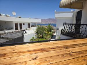 a deck with a view of the ocean on a house at Willa Sandal in Eilat