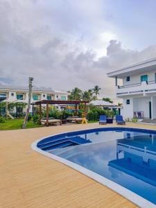 a villa with a swimming pool and a house at Areia do Atlantico Hotel in Porto Seguro