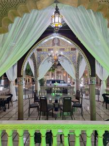 a pavilion with a chandelier and tables and chairs at Eden Suites  +162 photos