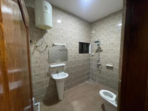 a bathroom with a toilet and a sink at Comfort Stay Apartments Cadjehoun in Cotonou