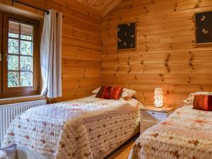 a bedroom with two beds and a window at Bluebell -Uk48309 in Staintondale