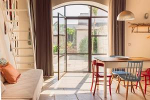 a living room with a table and chairs and a window at Galeta Masseria in Nardò