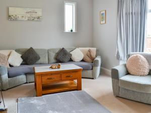 a living room with a couch and a coffee table at Eldon Cottage in Hornsea