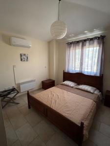 a bedroom with a bed and a desk and a window at Stunning Traditional Stone Villa - Kallepia in Kallepia +35 photos