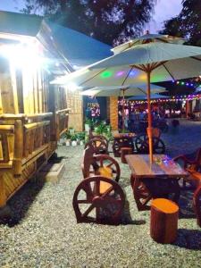 a picnic table with an umbrella and a table with chairs at Sea-Sky Blue Beach Resort at Malabrigo Lobo Batangas-TW in Lobo