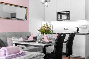 a dining room with a table with a vase of flowers at Ferienwohnung Harmonie mit Pool in Sankt Englmar