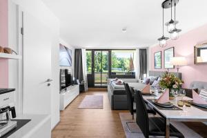 a living room and dining room with a table and chairs at Ferienwohnung Harmonie mit Pool und Fitness in Sankt Englmar