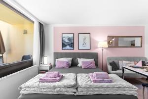 a bedroom with a bed with pink pillows on it at Ferienwohnung Harmonie mit Pool in Sankt Englmar
