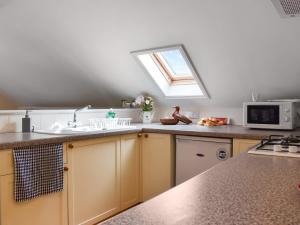 a kitchen with a sink and a window at Lavrean Farm in St Austell