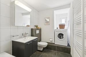 a bathroom with a toilet sink and a washing machine at Klara 1022 - Olma, Spital, Uni St- Gallen in St. Gallen