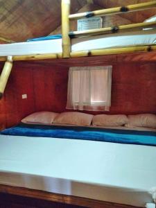 two bunk beds in a room with a window at Sea-Sky Blue Beach Resort at Malabrigo Lobo Batangas-TW in Lobo