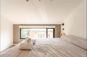 a bedroom with a large bed with two pillows on it at El Filo Aparts de Montaña in El Chalten