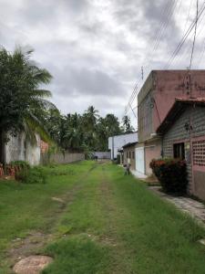an empty street in a village with a building at Especial Beira Mar in Maragogi +13 photos
