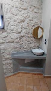 a bathroom with a sink and a stone wall at The Little Beach Cottage in Sidi Kaouki +46 photos