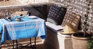 a table with a blue and white table cloth on a couch at The Little Beach Cottage in Sidi Kaouki
