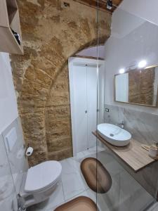a bathroom with a white toilet and a sink at A Casa Do Paisi - Realmonte in Realmonte