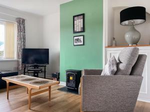 a living room with a couch and a table at Mum's Place in Hay-on-Wye