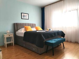a bedroom with a bed and a chair and a window at Apartments Gvacic in Rab +43 photos