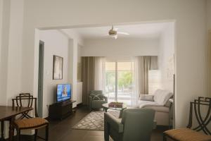 a living room with a couch and a table at Verdant Escape Corfu in Corfu