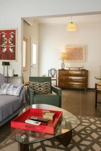 a living room with a couch and a coffee table at Verdant Escape Corfu in Corfu