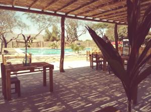 a patio with tables and chairs in front of a pool at Babylon Mansion in Nazca