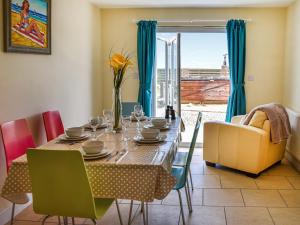 a dining room with a table and chairs at The Seas Beach House in Bacton