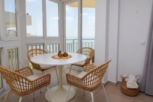 a white table and chairs in a room with a balcony at Ref 200 in Las Lagunas Mijas