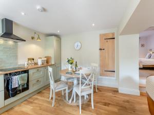 a kitchen and dining room with a table and chairs at Courtyard Cottage in Reeth