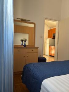 a bedroom with a bed and a kitchen with a kitchen at Apartment Ivic in Bol +8 photos