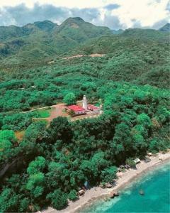 an island with a lighthouse in the middle of a mountain at Sea-Sky Sky Blue Beach Resort at Malabrigo Lobo Batangas in Lobo