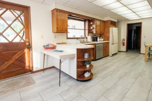 a kitchen with a sink and a counter in a room at Oakridge House. Spacious and historic home in downtown Ironton, Ohio. in Ironton +37 photos