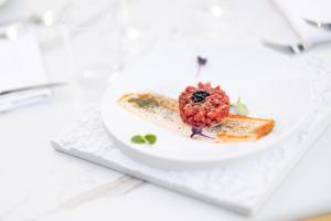 a plate with a dessert on a white table at Pagoda Lifestyle Hotel in Ischia